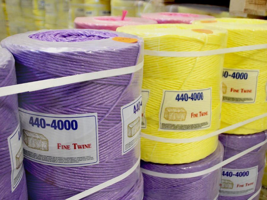 Fine Twine 440-4000 baler twine spools in purple and yellow